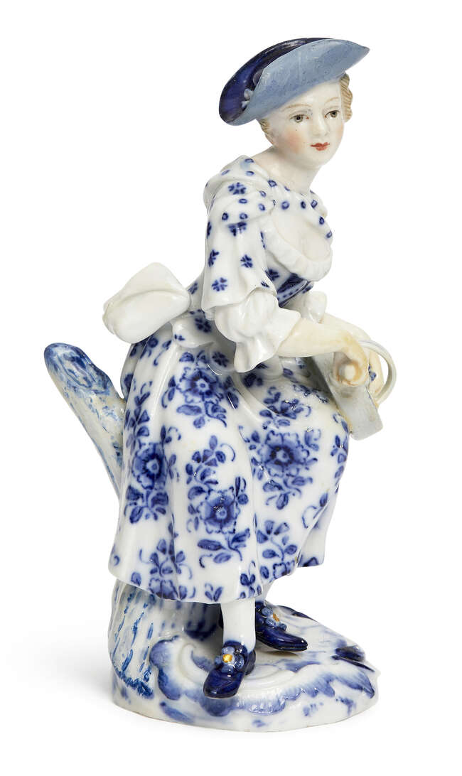 
	
		A Meissen blue and white porcelain figure of a lady playing a Hurdy-gurdy from the...