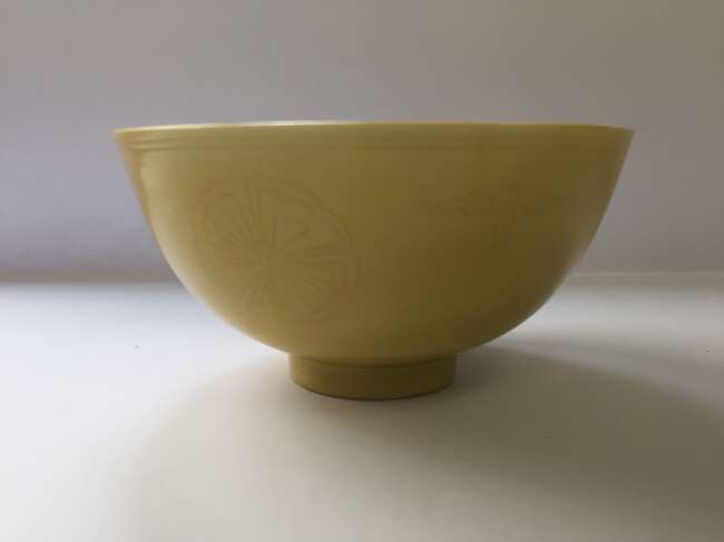 
	
		A Chinese porcelain incised yellow-glazed bowl, Kangxi mark and of the period, incised to...