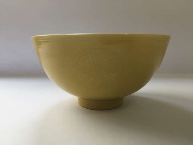 
	
		A Chinese porcelain incised yellow-glazed bowl, Kangxi mark and of the period, incised to...