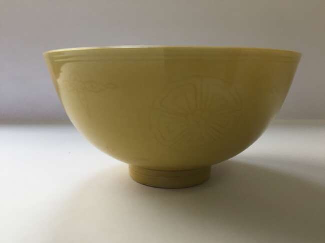 
	
		A Chinese porcelain incised yellow-glazed bowl, Kangxi mark and of the period, incised to...