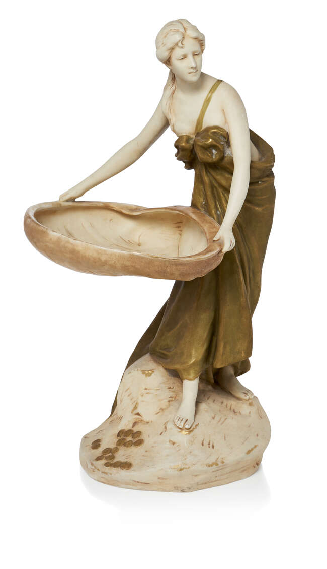 
	
		Royal Dux, a bisque porcelain figural tazza 
		c.1910, applied pink triangle Royal Dux...