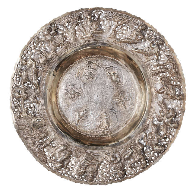 
	
		A Burmese repousse silver dish, Burma, early 19th century, of shallow form, engraved to...