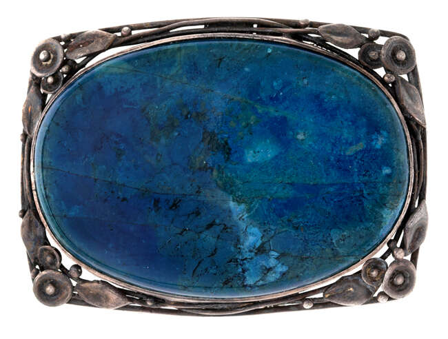 
	
		An Australian Arts & Crafts  silver and hardstone brooch, by Wager, designed as an oval...