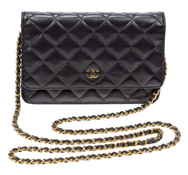 
	
		A Chanel clutch bag, the rectangular form black leather body designed with central Chanel...