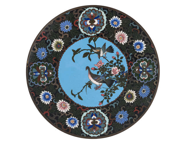 
	
		A Japanese cloisonne dish, late 19th century, centred with exotic birds amidst blossoming...
