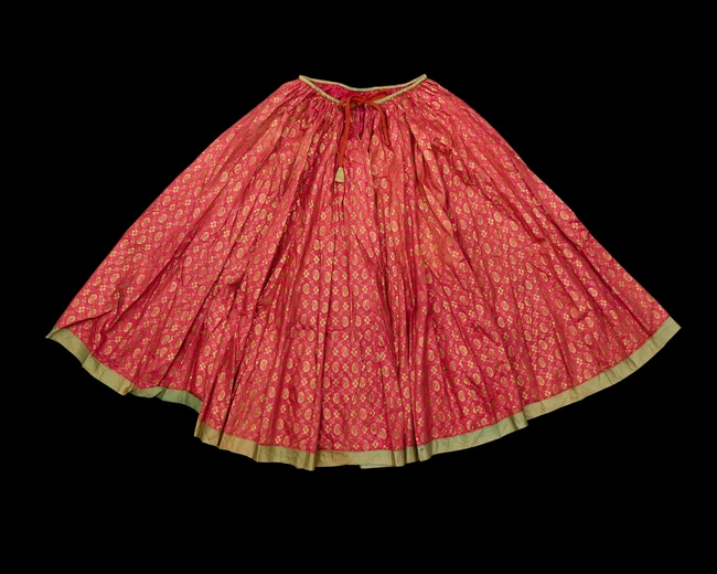 A pink silk nautch skirt, India, 20th century, 
a wavy lattice filled with botehs, on dark...