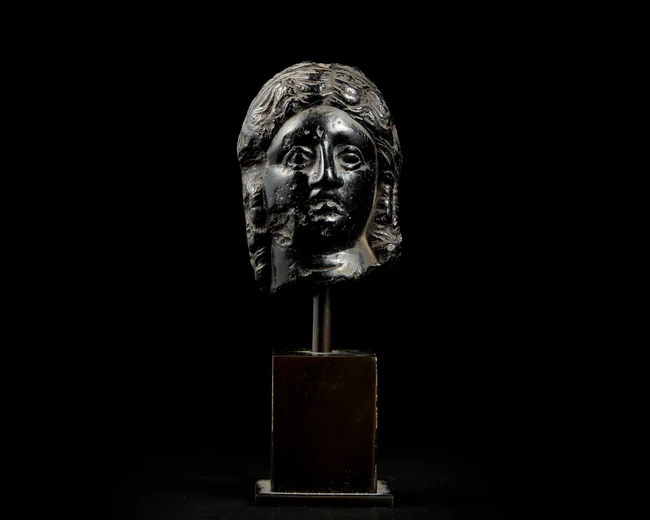 An Egyptian basalt head of a queen or goddessHellenistic, Ptolemaic dynasty, circa 300 - 30...