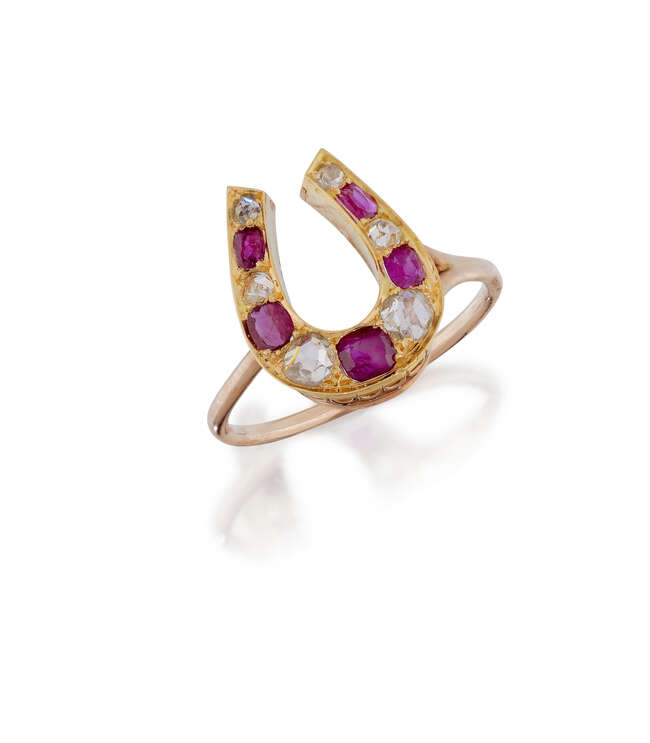 
	
		A ruby and diamond horse shoe ring, the horse shoe design bezel set alternately with...