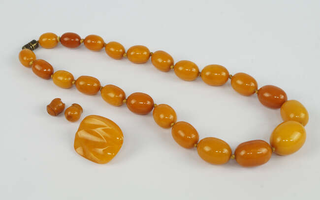 
	
		A butterscotch ambroid graduated bead necklace, 45cm long, together with a similar brooch...