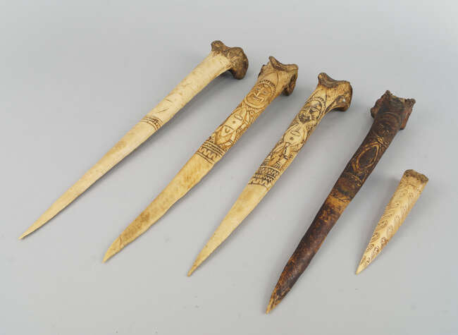 
	
		Five Sepik Cassowary bone daggers, three with carved figural decoration of stylistic male...