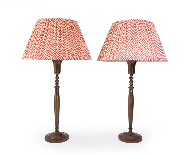 A pair of French bronze twin-light table lamps, second quarter 20th century, each with flared...