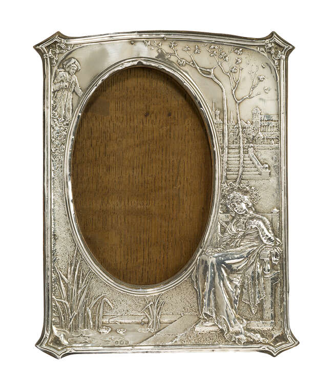 
	
		An Edwardian silver and oak photograph frame
		Mark of M. & C. Lister Ltd, Birmingham...