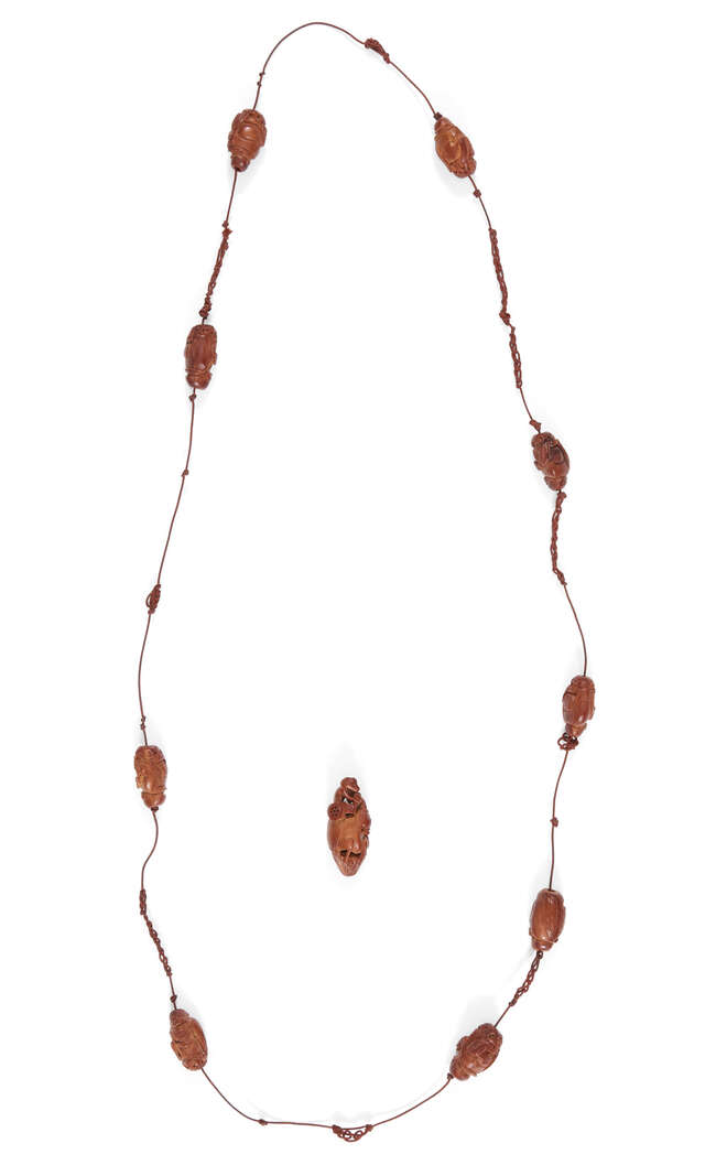 
	
		A Chinese hediao nut nine bead rosary, 20th century, each bead carved as a monk holding...