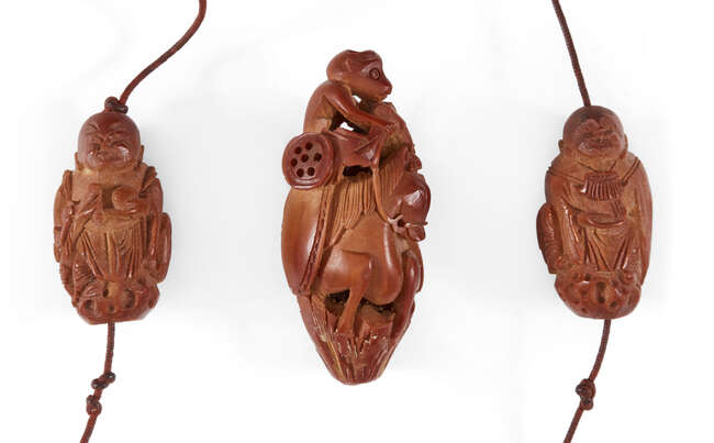 
	
		A Chinese hediao nut nine bead rosary, 20th century, each bead carved as a monk holding...