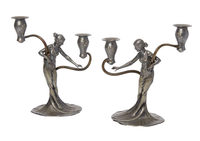 
	
		WMF, a pair of Art Nouveau pewter and brass figural candelabra
		c.1906, faint stamped...