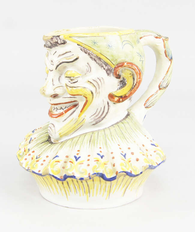 
	
		A Continental tin glazed earthenware jug, modelled a Mr Punchinello, with initial JG to...
