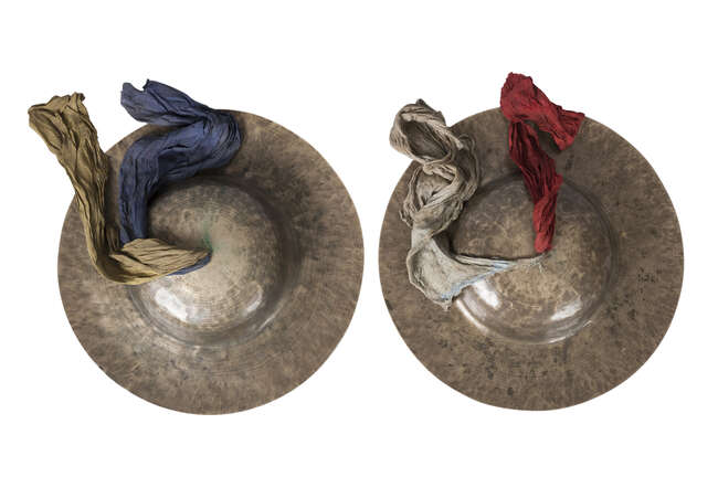 
	
		A pair of Tibetan beaten brass cymbals, 19th century, with cloth handles and painted...