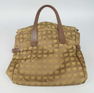 
	
		A Chanel Travel Line gold and bronze monogram nylon tote bag, brown leather handles and...