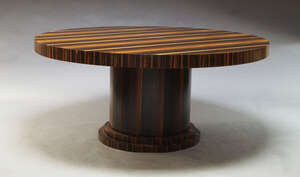 
	
		An Art Deco style coromandel dining table, of recent manufacture, the circular top on...