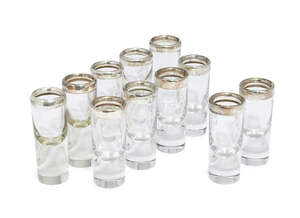 
	
		A harlequin set of eleven German silver topped shot glasses, 800 fineness, various...