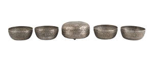 
	
		A repousse work silver lidded bowl with Kris motif, and four matching bowls, South Asia,...