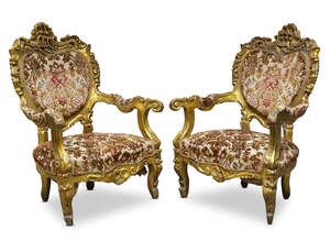 
	
		A pair of French Rococo style giltwood fauteuils, early/ mid 20th century, with overall...