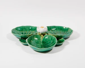 A Minton majolica lilypad centrepiece, date code for 1865, impressed and inscribed marks to the underside, modelled with a lily to the centre surrounded by thr