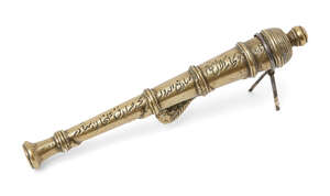 
	
		A brass model of a cannon, inscribed, and dated 1244AH/1828AD, India,15cm. long...