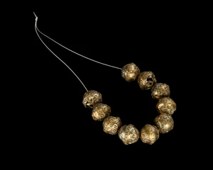 Ten gilded silver beads, possibly Safavid,Iran, 18th century
The bulbous hollow beads with...