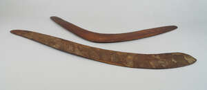 
	
		A carved Tribal club, carved with stylised grooved patterning, 70.7cm wide, together with...