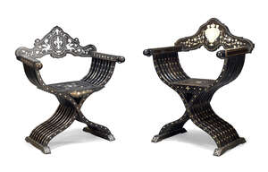 
	
		A late Victorian ebonised and ivory inlaid Savonarola armchair, the shaped backrest...