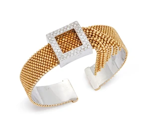 A diamond torque bangle, with brilliant-cut diamond buckle form panel with bead-link chain...