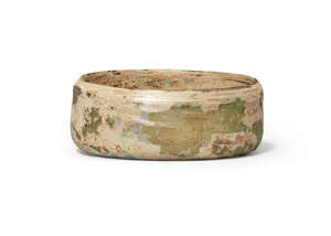 An iridescent glass bowl/lid, Roman or later, 7.2cm diam, 2.8cm high
Provenance: Private UK...