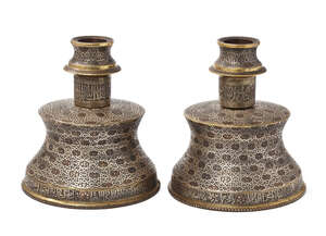 
	
		Two large silver- and copper-inlaid brass candlesticks in the Mamluk style, Egypt or...