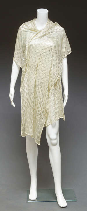 
	
		An Egyptian wedding shawl, silver panels on a cream net ground, 240cm 

	

