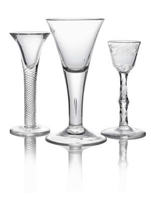 A George III wine glass, with tapering bowl cut with a band of scrolling foliage and birds, on facetted cut stem with spreading foot, 15.5cm high, together wit