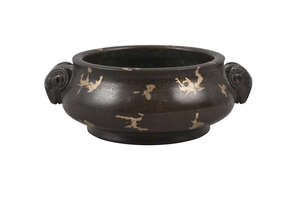 
	
		A Chinese bronze bombe censer, 20th century, with cast ram's head handles and...