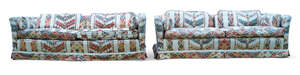 
	
		A pair of modern three seat sofas, late 20th century, with ivory and polychrome geometric...