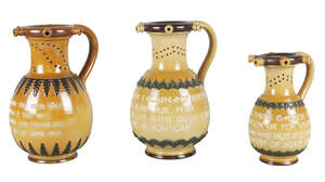 
	
		Three Doulton Lambeth stoneware puzzle jugs, each with a different motto in applied...