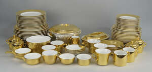 A Royal Worcester porcelain part dinner service with twelve settings, decorated with a thick gold edge, to comprise twelve dinner plates, twelve smaller plates