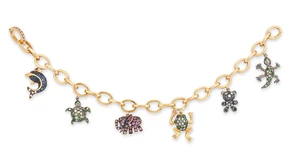 An Italian diamond and gem-set charm bracelet, designed as an oval trace link chain suspending a...
