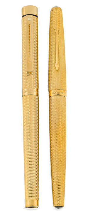 An 18ct gold Parker fountain pen, designed with hooded nib and engine turned gold barrel and...