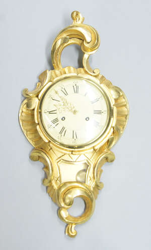 
	
		A Continental giltwood cartel clock, late 20th century, the case with scrolls to top and...