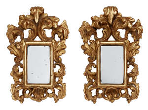 
	
		A pair of Florentine small carved giltwood mirrors, early 19th century, with foliate...