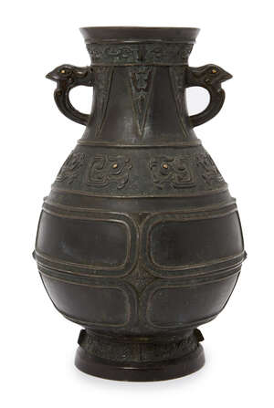 
	
		A Chinese bronze archaistic vase, hu, 17th century, cast with bird's mask handles with...