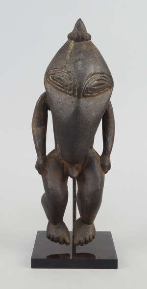 
	
		A Sepik Ramu ancestor figure bird form, with pointed head finial and carved eyes with...