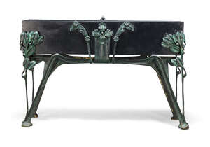 
	
		An Art Nouveau style planter, 20th century, with black painted trough on green patinated...