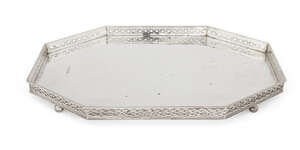 An elongated octagonal silver tray, Birmingham, c.1924, Albert Edward Jones, raised on four ball feet with hammered base and sides decorated with pierced rope 