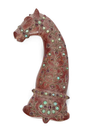 
	
		A ruby- and turquoise-set red hardstone hilt, India, late 19th century, the terminal in...