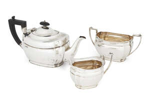 A three piece silver tea set, Sheffield, c.1923, Alexander Clark & Co., comprising a teapot, sugar dish and milk jug, all of rectangular form with single band 